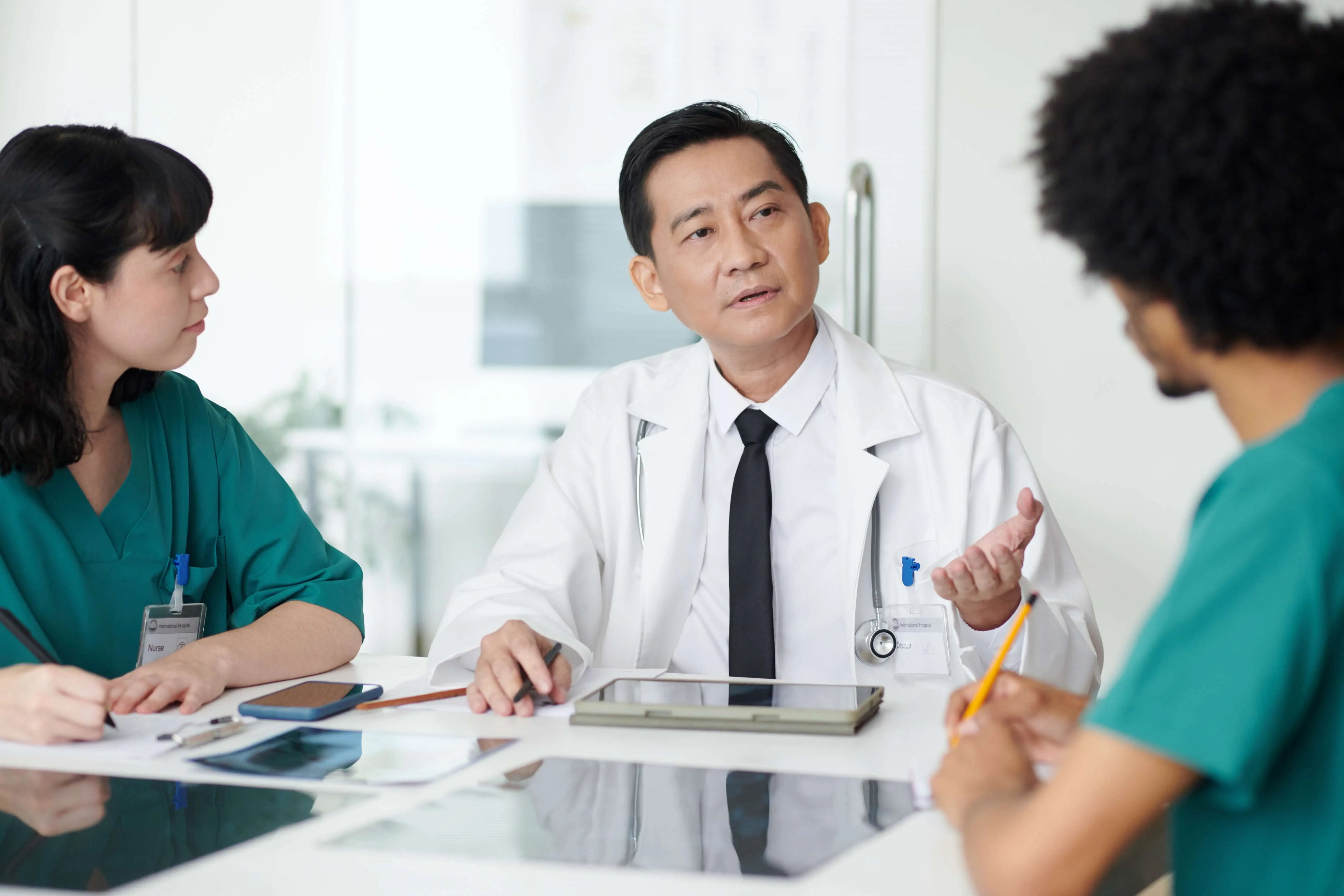 2nd.MD doctors looking at tablet